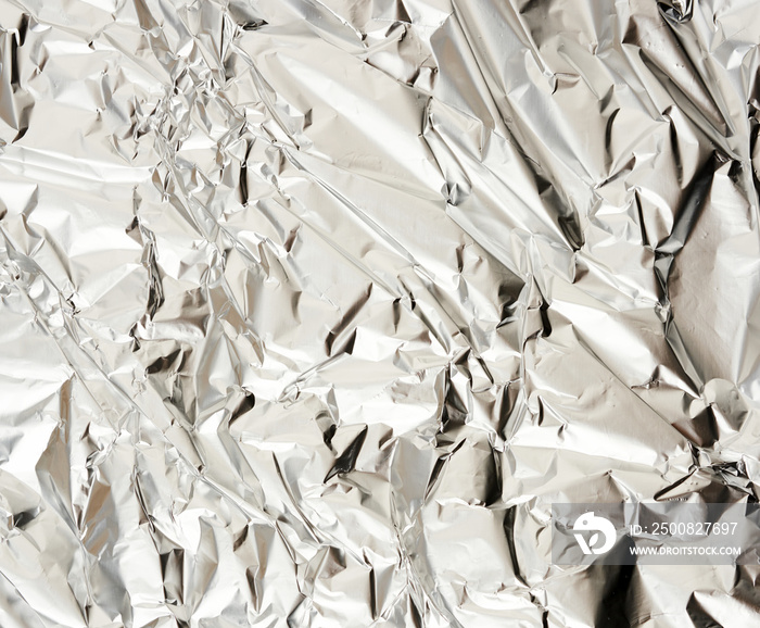 texture of matte crumpled piece of foil, food and objects packaging material, close up