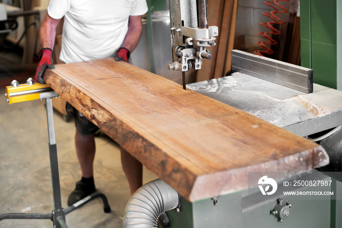 Woodworker cutting a large panel with a band saw