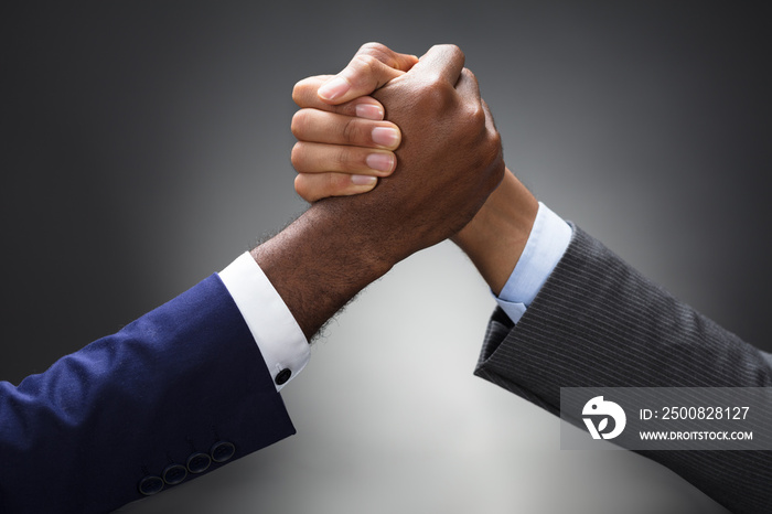 Two Businessman Competing In Arm Wrestling