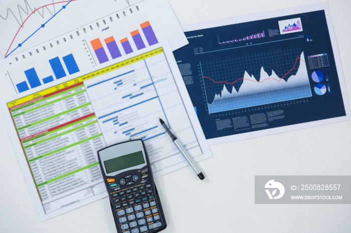 Close-up of graphs, documents and calculator