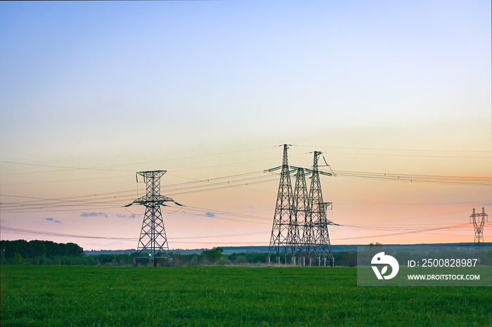 High voltage power line on industrial electricity line tower for electrification rural countryside.