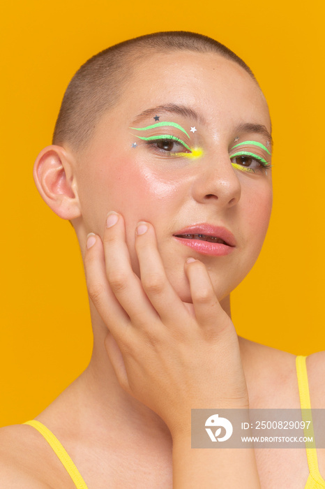 Studio portrait of girl with neon colored make-up