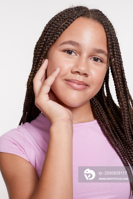 Studio portrait of smiling girl with braided hair