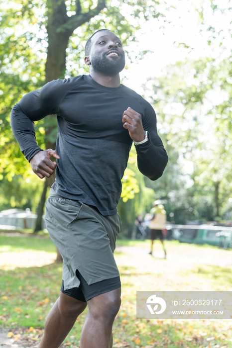 Athletic man jogging in park