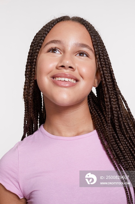 Studio portrait of smiling girl with braided hair