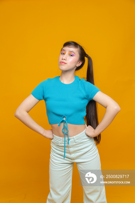 Studio portrait of girl with hands on hips