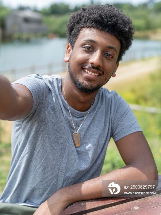 Portrait of smiling man by lake