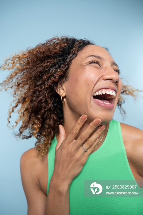 Portrait of woman with curly hair, laughing