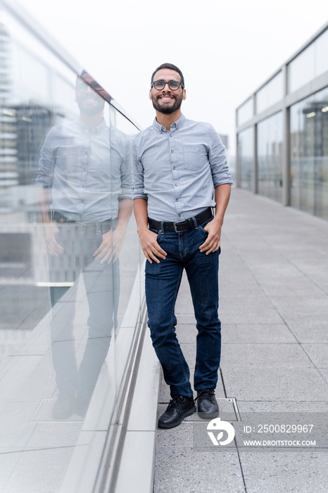 Office worker posing against office buildings