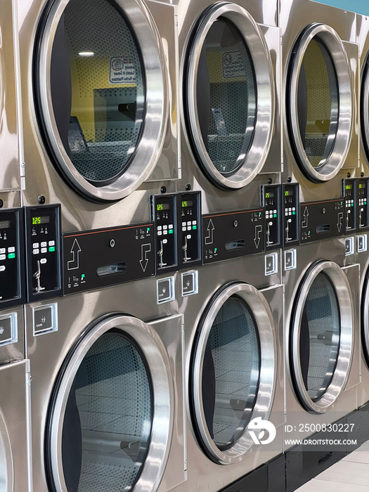 A row of washing machines at the laundromat/