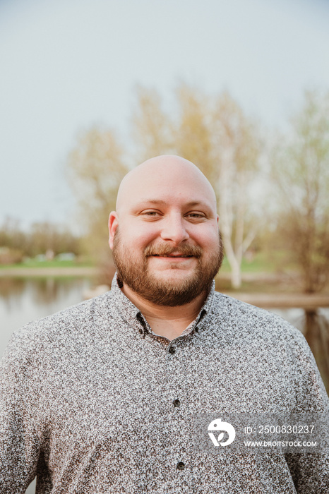 closeup of plus size bald man looking at camera