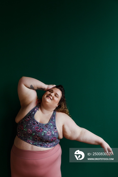 portrait of a plus size person stretching and moving