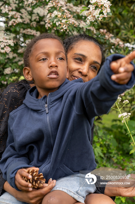 Mother and son sitting in garden