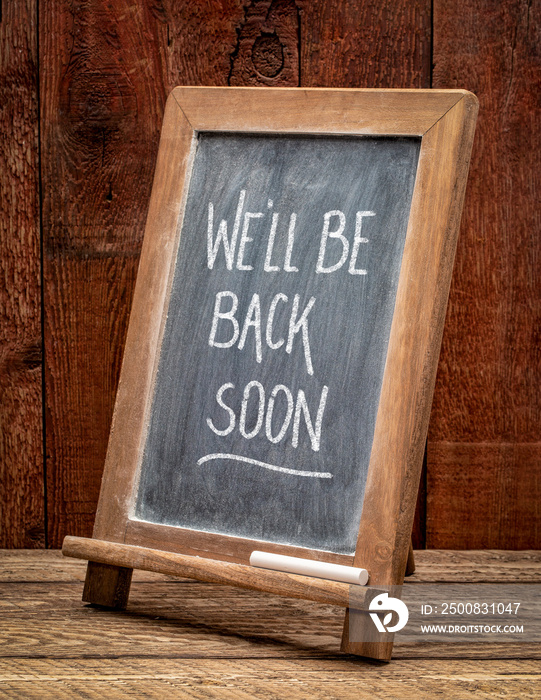 We will be back soon - white chalk handwriting on a blackboard, business reopening after coronavirus pandemic.