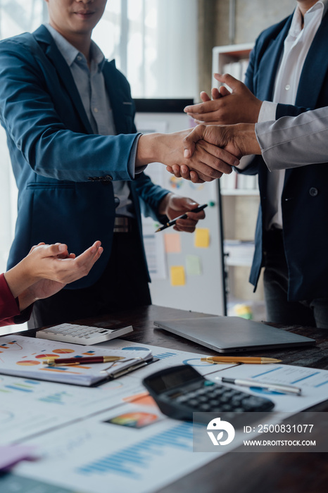 Group business workers handshake at meeting at office meeting room, from joint investment and success in the project after meeting stock market project.