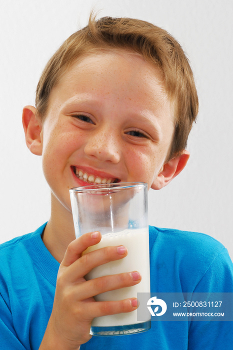 happy kid drinking glass of milk on white background