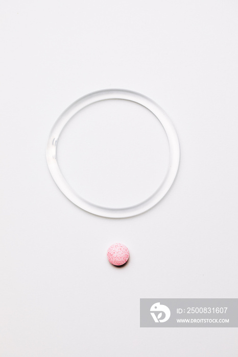 hormone ring and tablets on a white background. Contraceptive ring