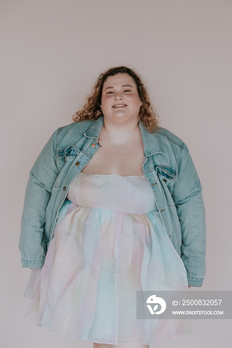 portrait of a plus size woman wearing a denim jacket