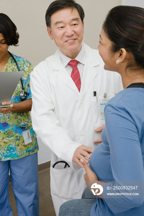 A doctor examining a pregnant patient