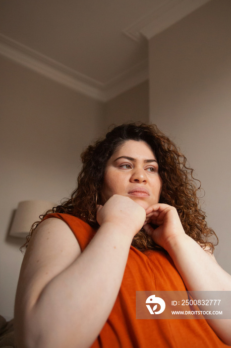 Plus-sized Sri Lankan woman with vitiligo meditating in her bedroom