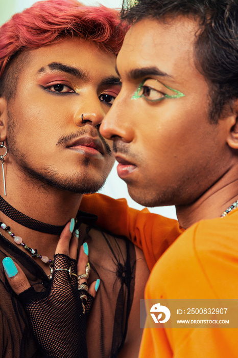 Malaysian Indian men posed in front of a cloth backdrop in a studio setting