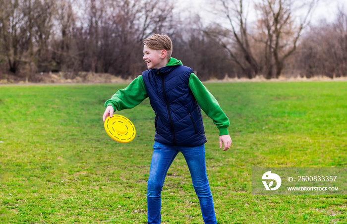 Teenager playing frisbee in the park