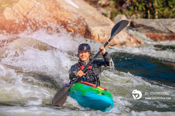 Guy in kayak sails mountain river. Whitewater kayaking, extreme sport rafting