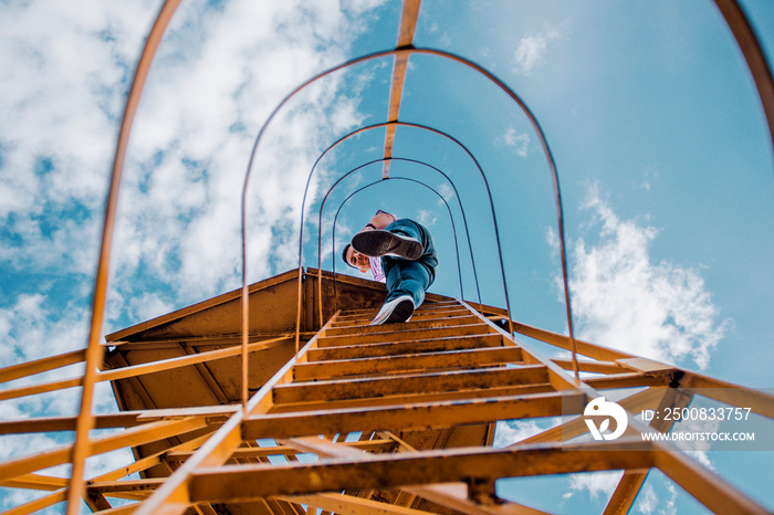 Man climbing on metal scale