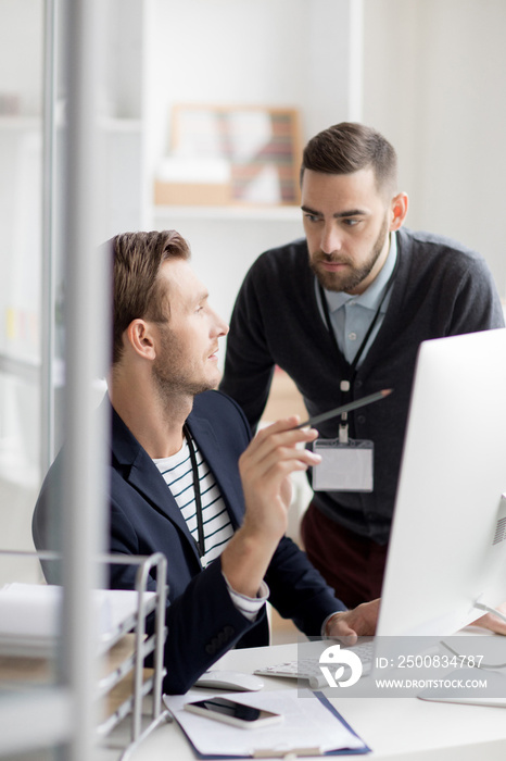 Portrait of two professionals discussing startup project while working in modern office