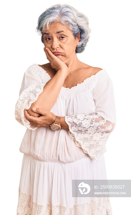 Senior woman with gray hair wearing bohemian style thinking looking tired and bored with depression problems with crossed arms.