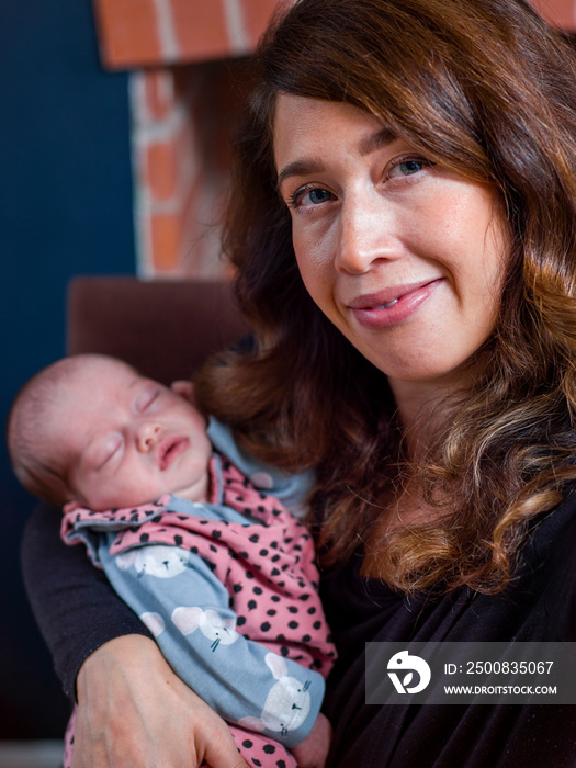 Portrait of smiling woman holding baby son   at home