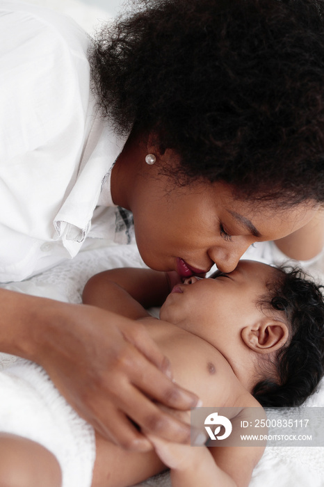 portrait of sleeping african american baby girl with mother