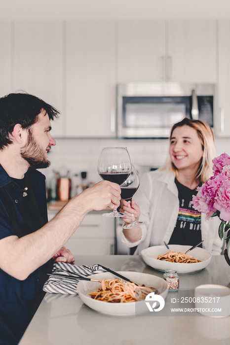 Family dinner. Pasta dinner with family. Delicious food and wine. Discussing the say during dinner. Laughing, talking. Gathering with food. Home cooking. Stay home and cook. Eat, drink, laugh.