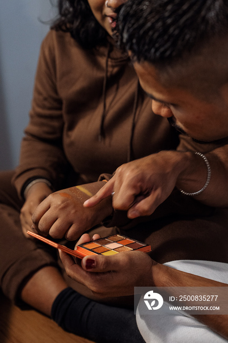 Group of friends doing each others make up at home during a sleepover