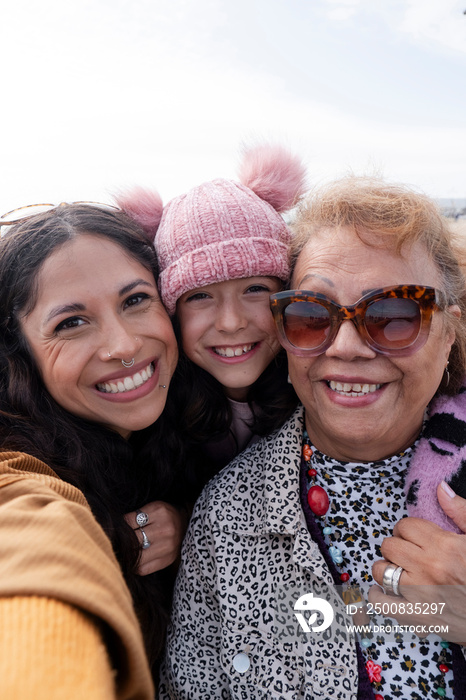 Grandmother, mother and daughter taking selfie