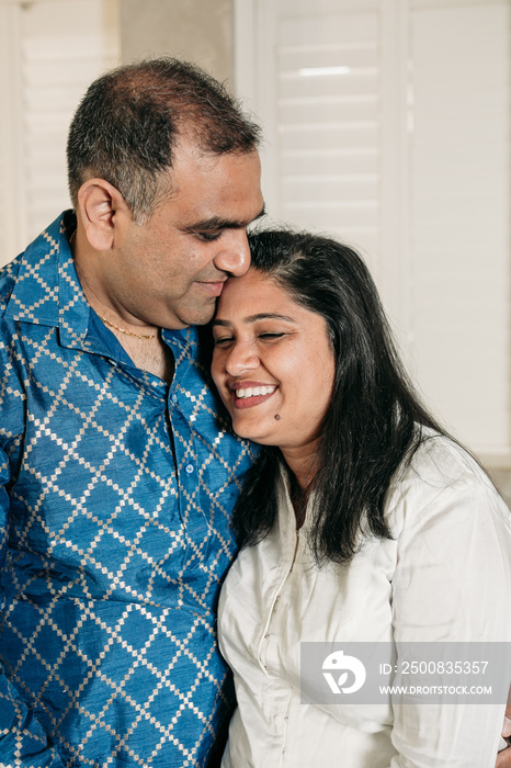 South Asian couple cooking in the Kitchen