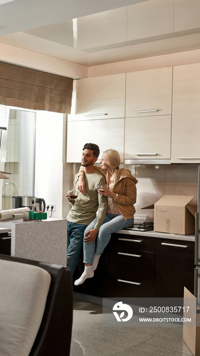 Multiracial couple rest and drink tea or coffee