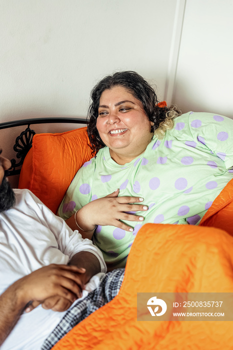 Couple chatting after waking up in the morning