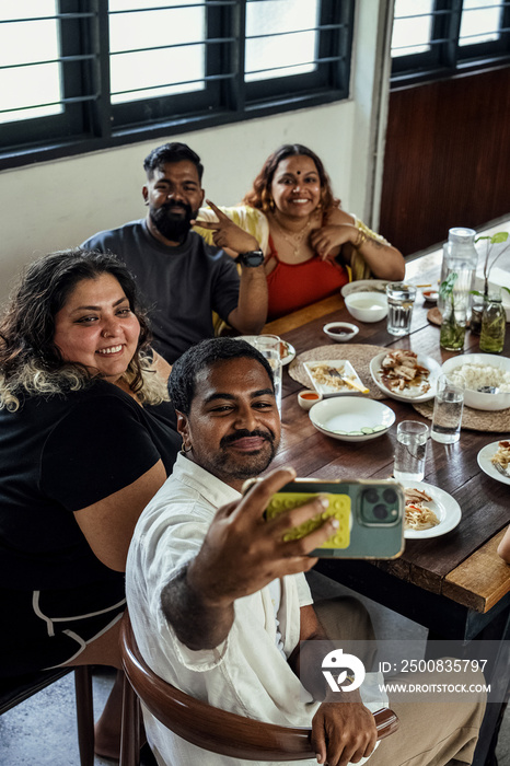 Group of friends sharing a meal together at home