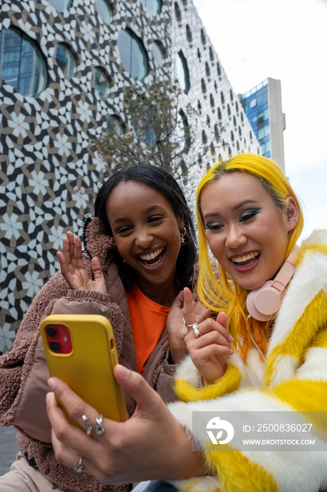 Smiling young friends having video call