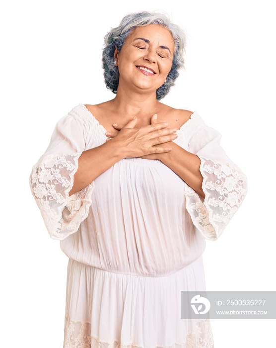 Senior woman with gray hair wearing bohemian style smiling with hands on chest with closed eyes and grateful gesture on face. health concept.