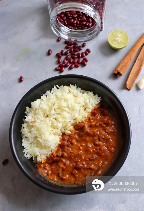 Rajma Chawal is a popular North Indian Food. Rajma is a socked Red kidney beans cooked with onions, tomatoes, and a special blend of spices. Served with Jeera rice or Cumin Rice. With Copy Space.