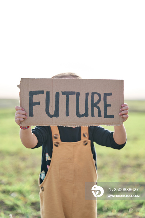 girl holding a sign that says future