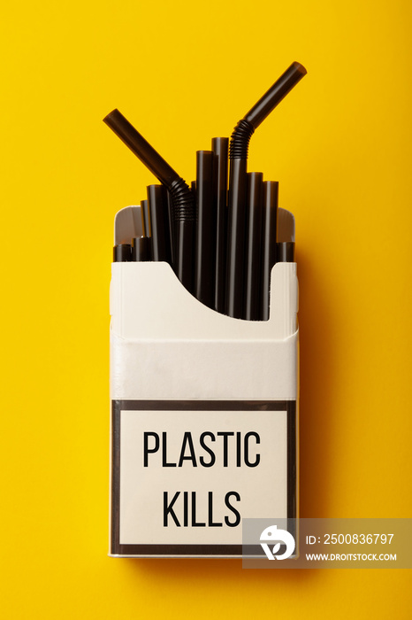 Disposable plastic straws in pack of cigarettes - plastic kills. Сoncept of environmental pollution, environmental damage from garbage. Save world.