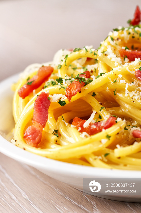 Traditional italian dish spaghetti carbonara with bacon in a cream sauce