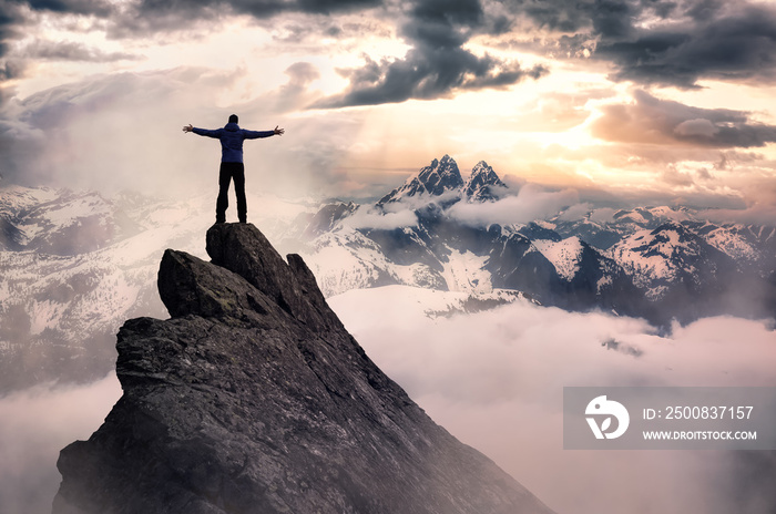 Magical Fantasy Adventure Composite of Man Hiking on top of a rocky mountain peak. Background Landscape from British Columbia, Canada. Sunset or Sunrise Colorful Sky