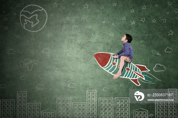 Little boy riding a rocket in chalkboard