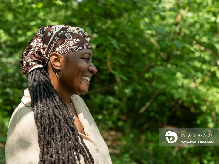 Smiling mature woman on hike in forest