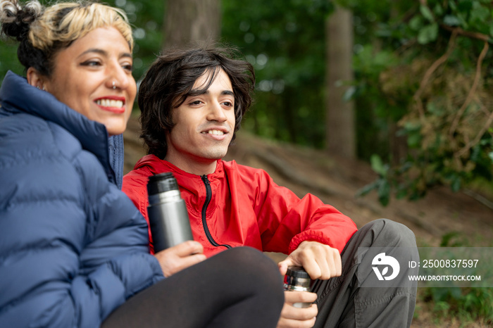 Mother and son relaxing in forest