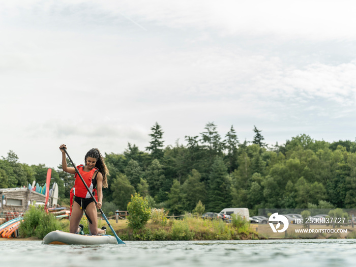 Woman paddleboarding on lake